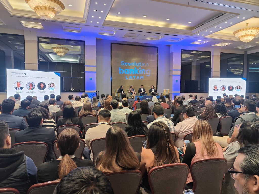 Panel discussion in front of packed audience